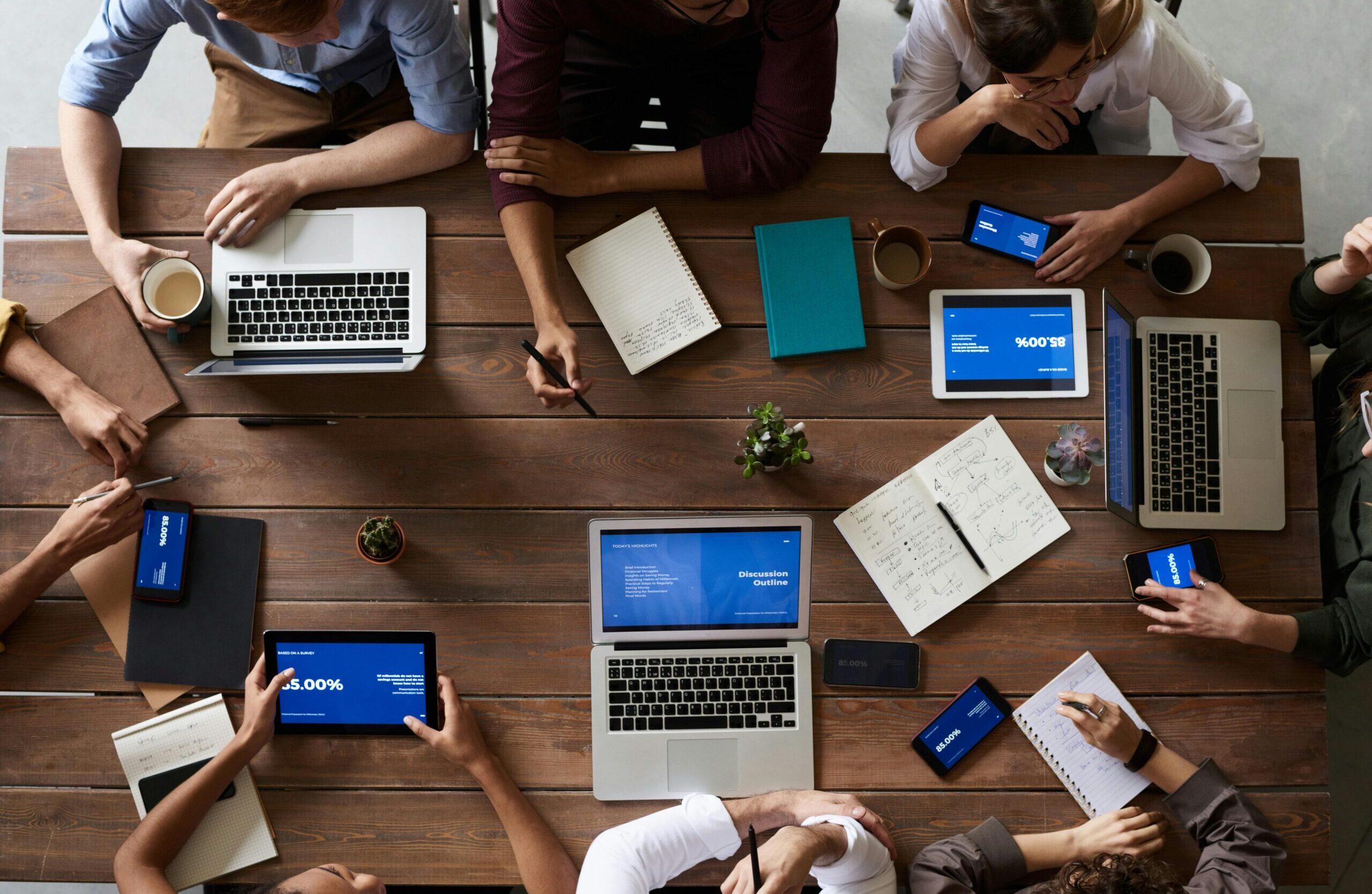 Top View Photo Of People Near Wooden Table